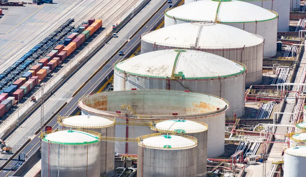 Aerial view of an oil tank farm beside a rail and container yard